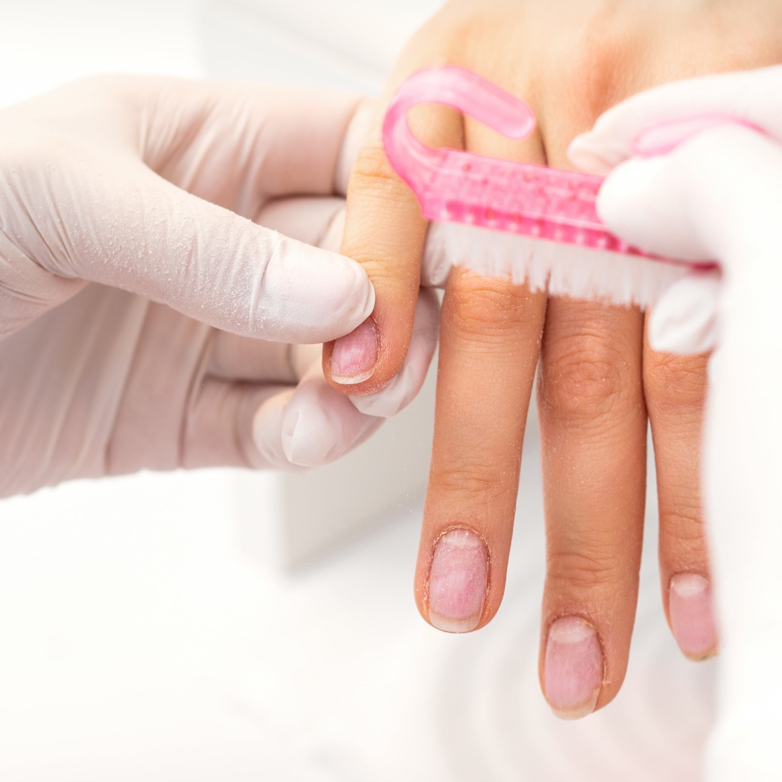nail tech giving client nail manicure
