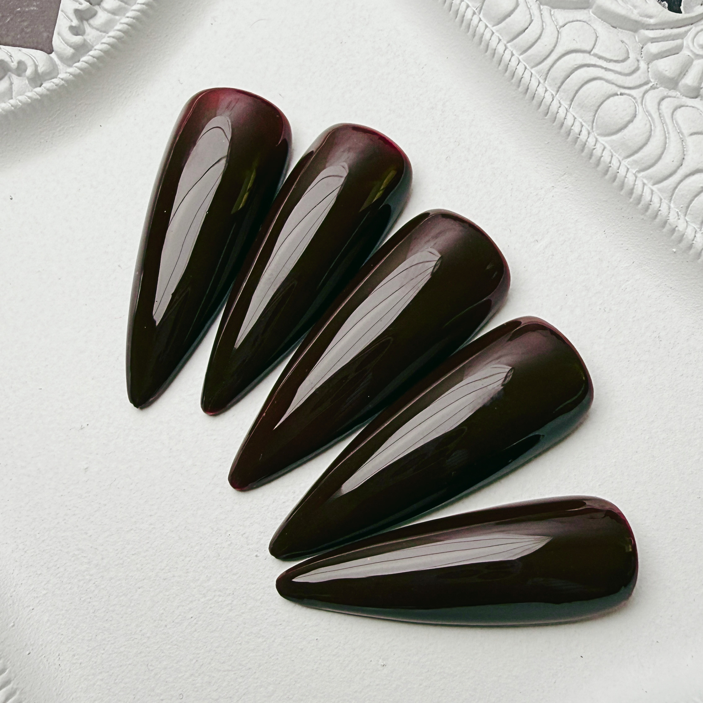 Luxury burgundy glossy press-on nail set called Widow's Wine from the House of Moonlight Foundation Collection, featuring a deep wine-inspired high-gloss finish.