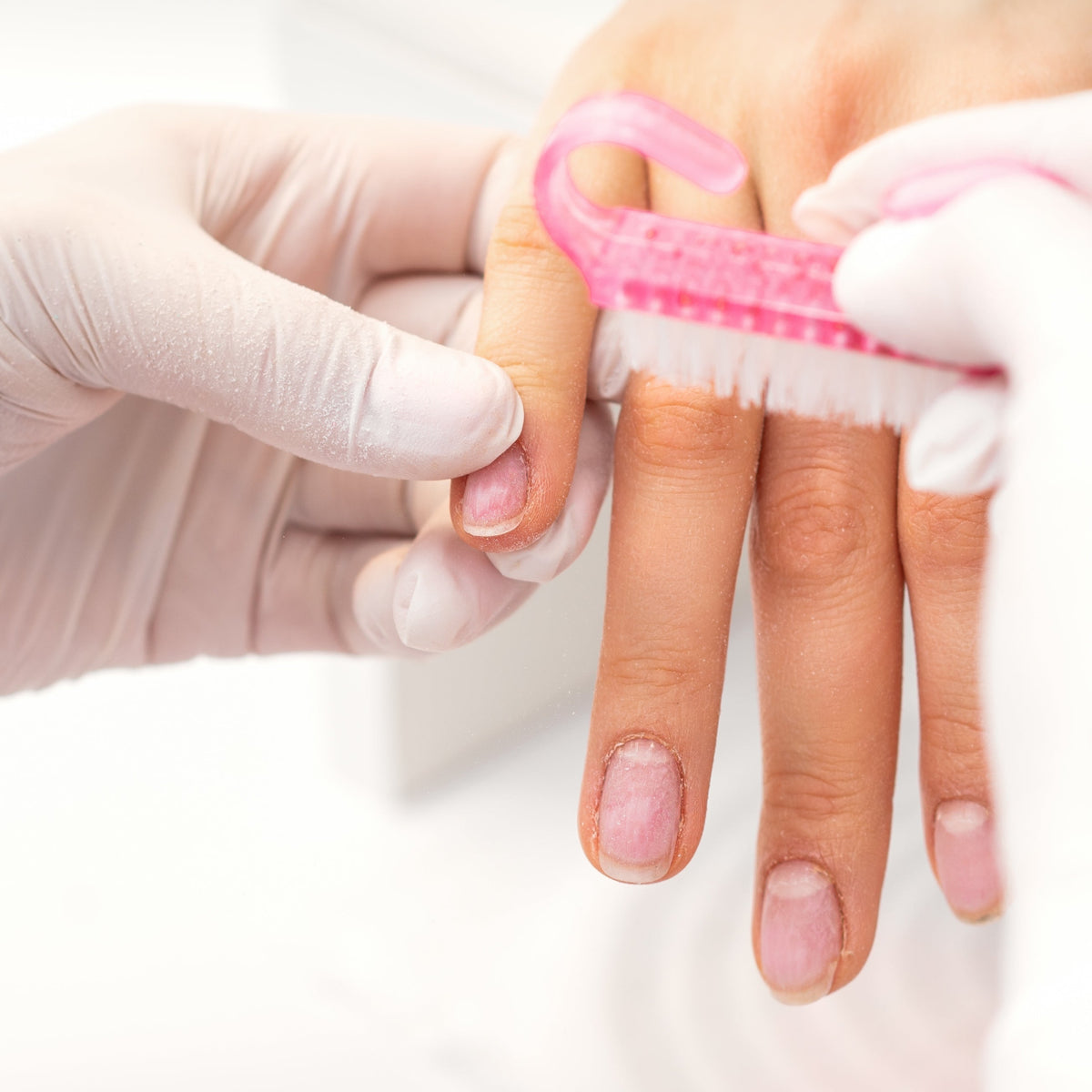nail tech giving client nail manicure